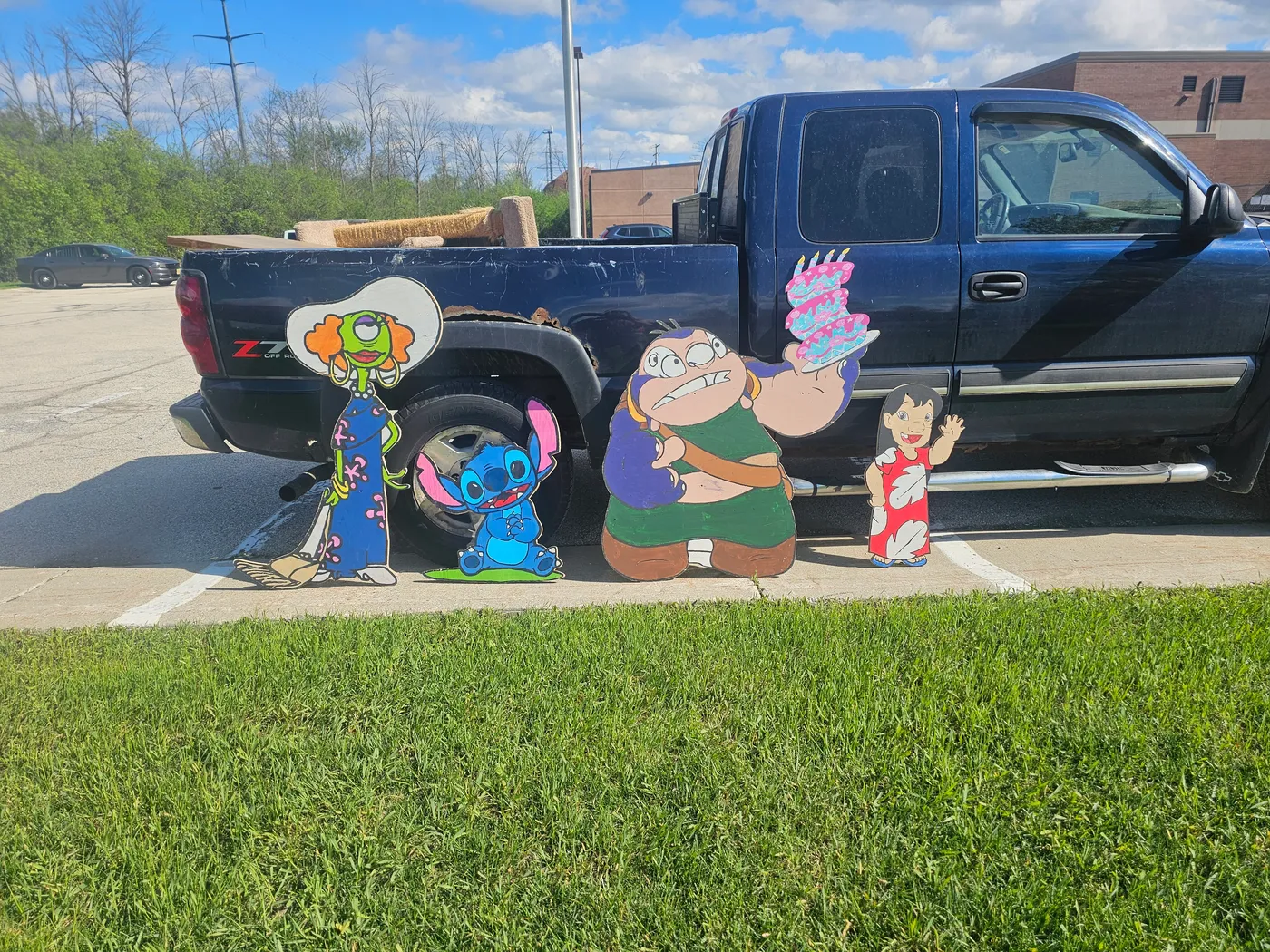 Custom hand-painted wood character cutouts displayed outdoors