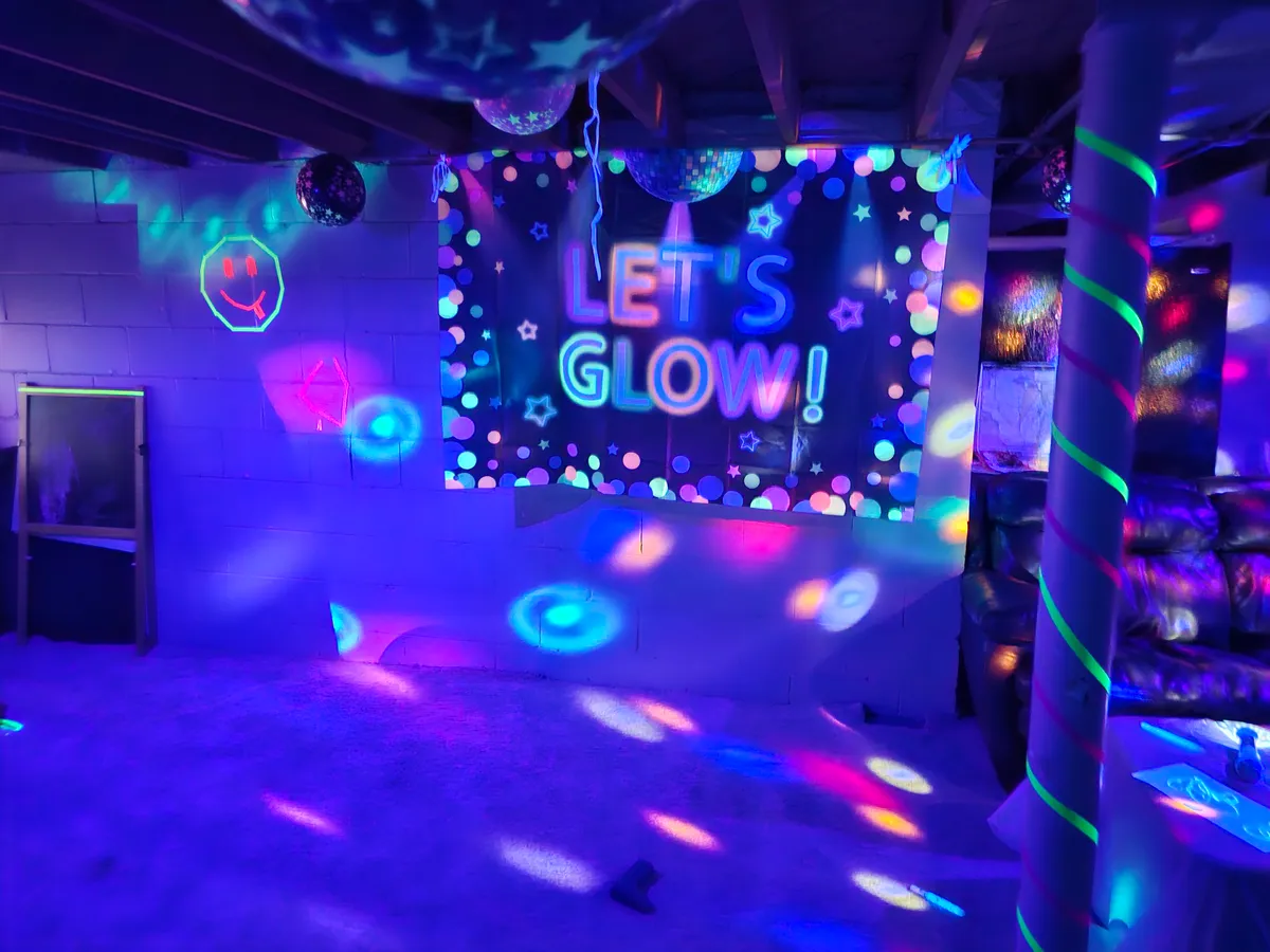 Glow party setup with LET'S GLOW banner and disco lights